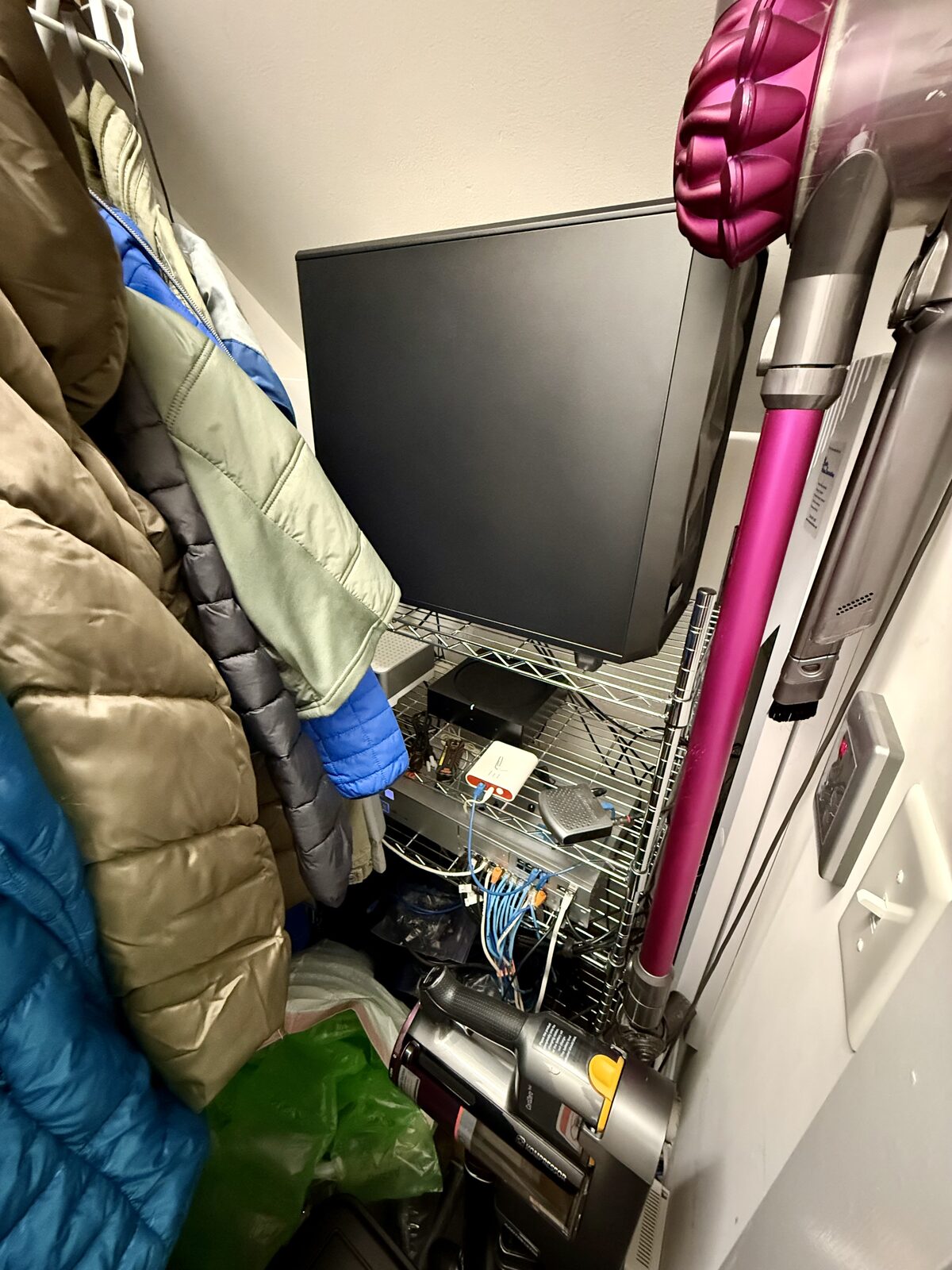 The coat closet data center, wedged between the winter coats and a vacuum