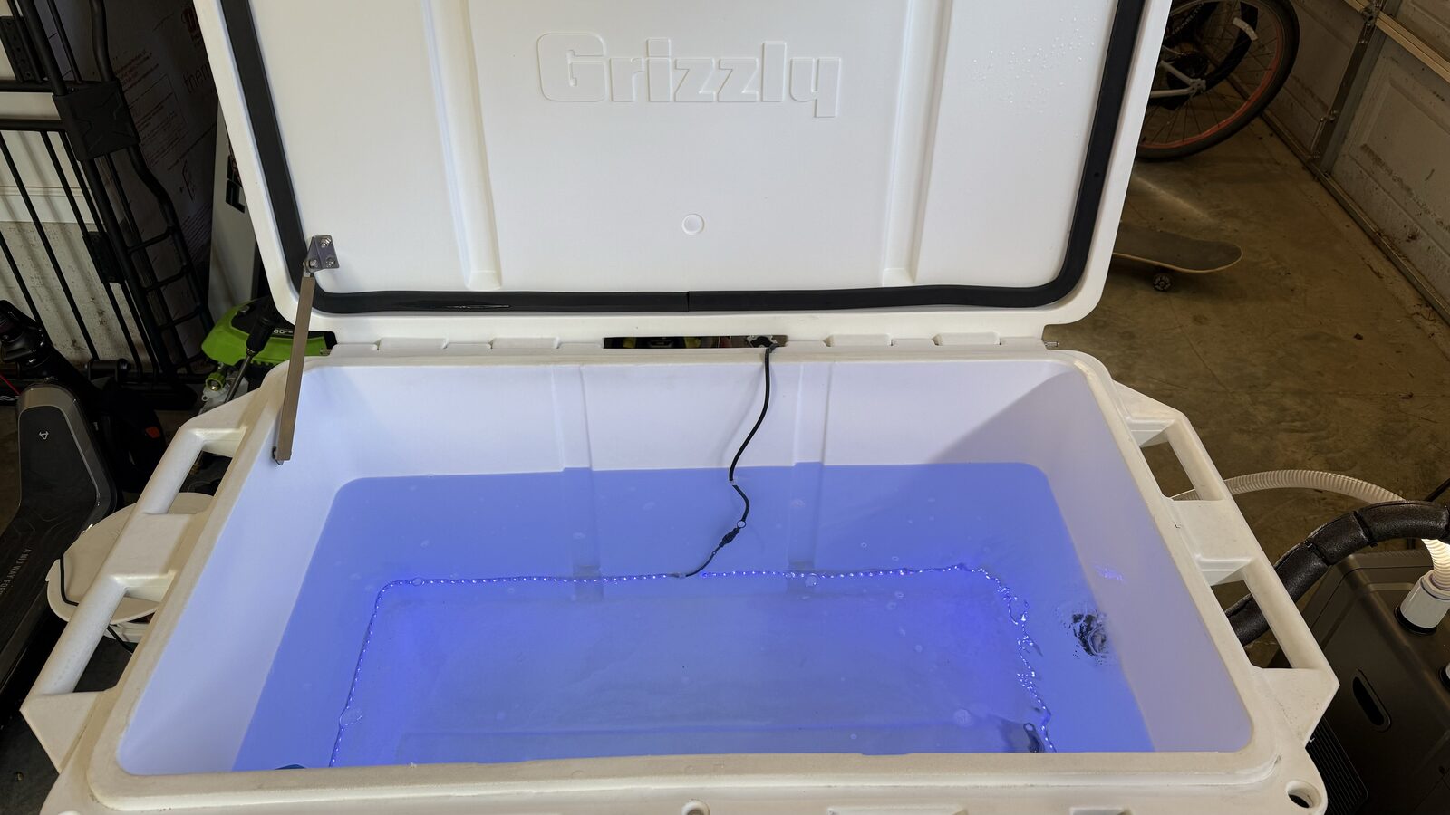 The homemade cold plunge with its color-changing interior lighting